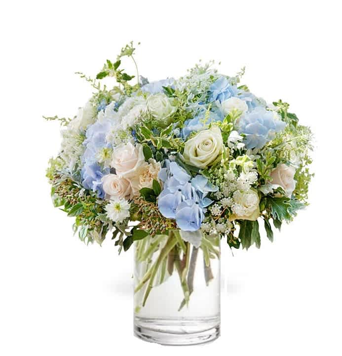Blue and white flower bouquet in a clear glass vase