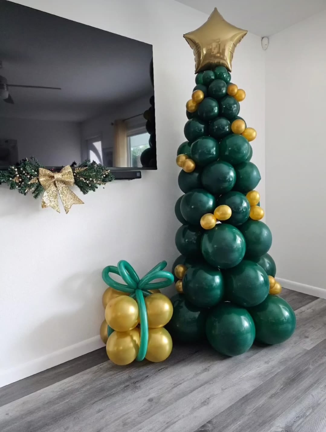 Balloon Christmas tree with gold star topper and gift-shaped balloon