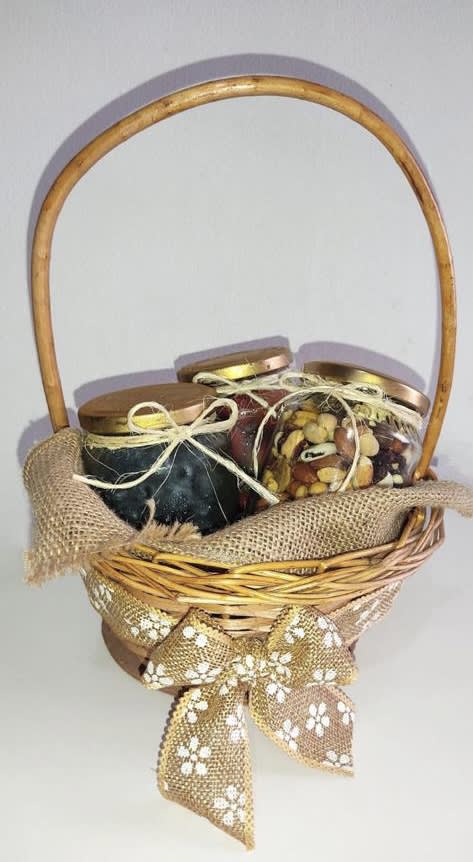Basket of three lidded jars tied with ribbon