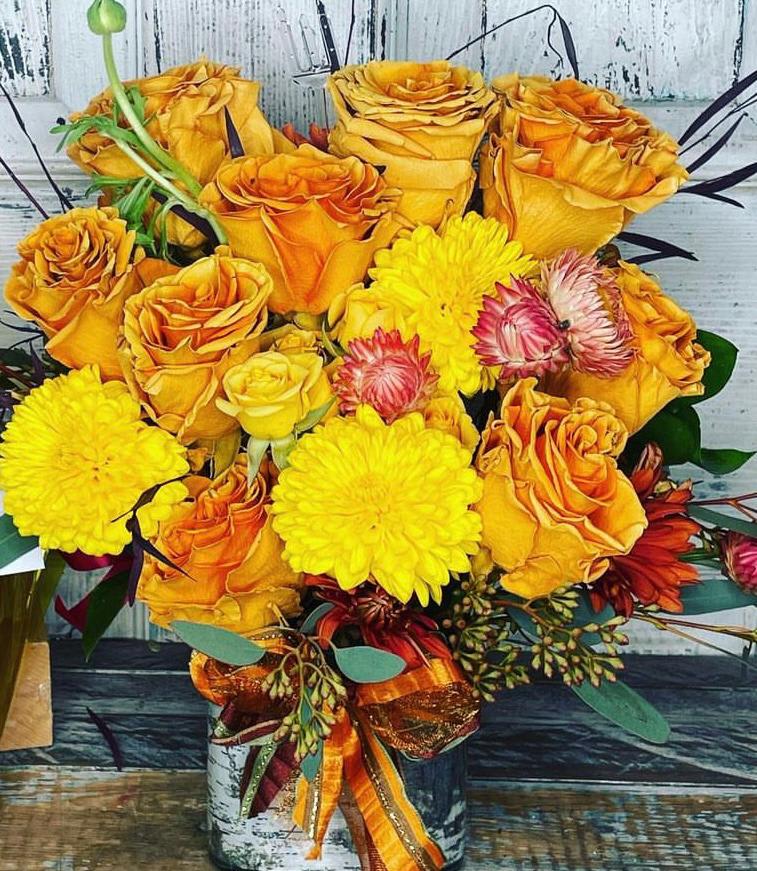 Bouquet of yellow and orange roses with bright yellow mums