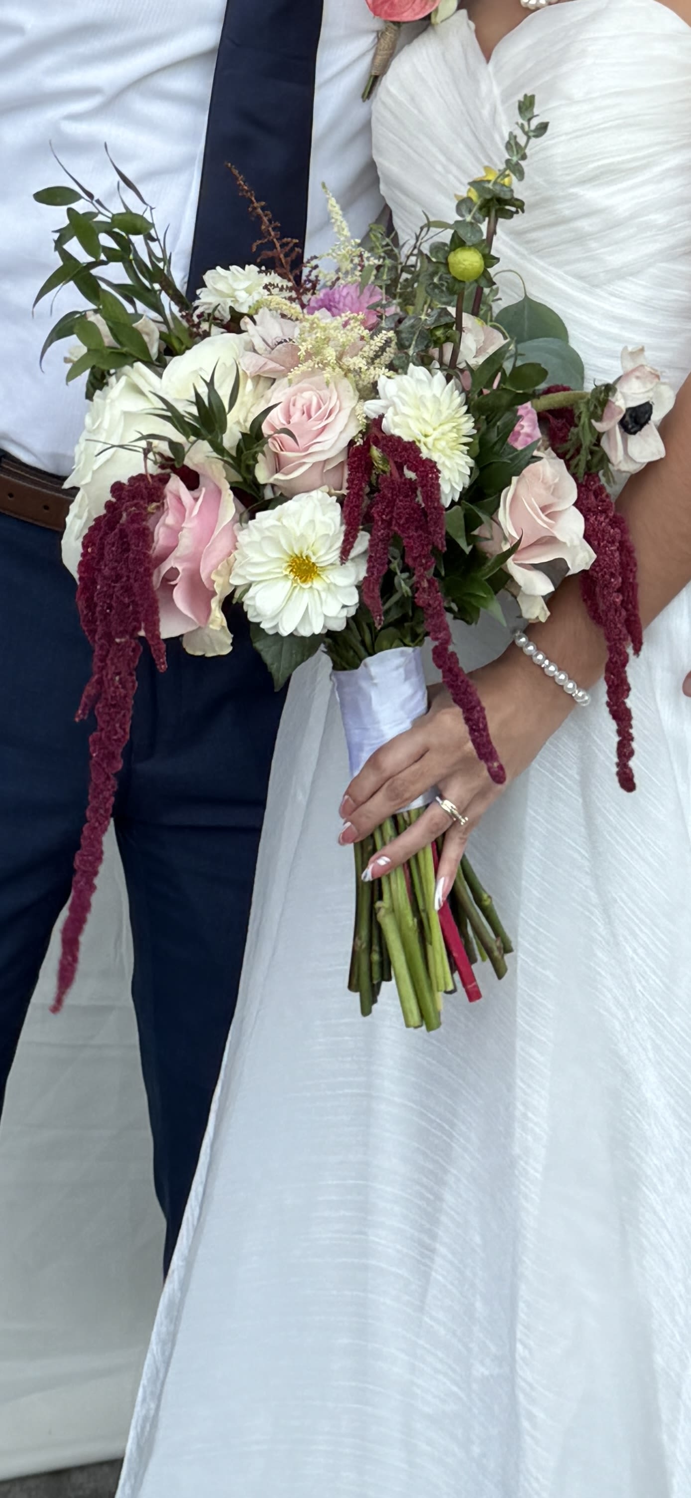 Bride holding a bouquet of pink and white flowers