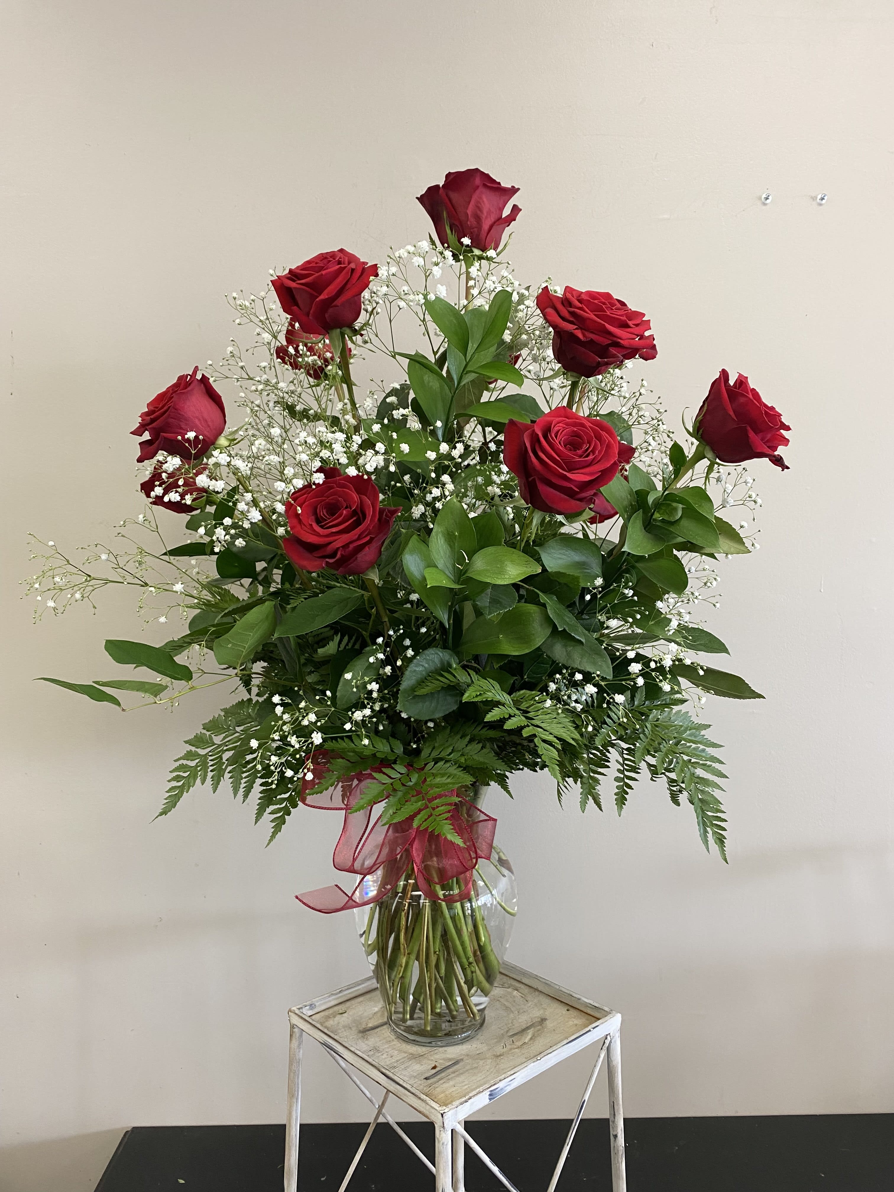 Classic Dozen Roses  - A dozen long stem red roses with baby's breath and assorted greenery in a clear glass vase. These roses are the perfect gift for anniversaries, birthdays, retirement, or even just because! Order for a same day or next day delivery and give us a call if you want custom flowers.  