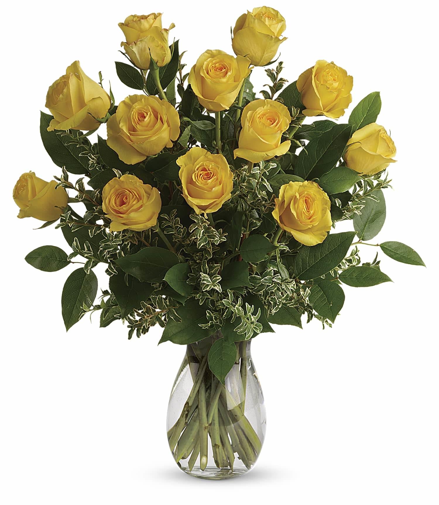 Yellow roses in a clear glass vase with mixed greenery