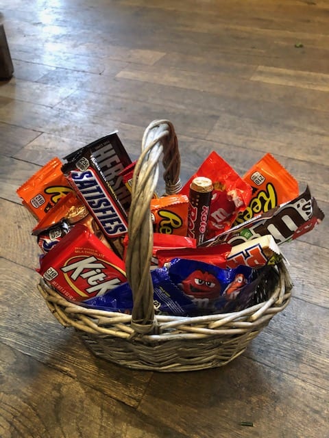 Wicker basket filled with assorted candy bars and chocolates