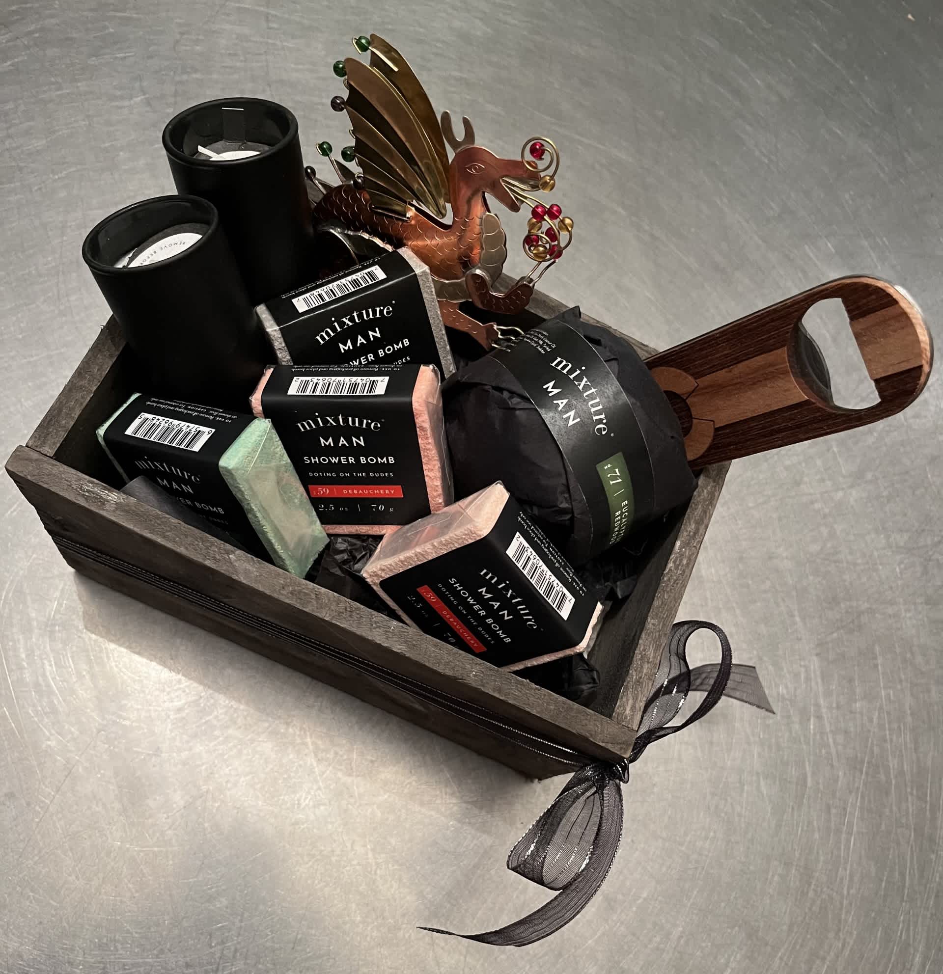 Gift basket with shower bombs, candles, and a metal dragon ornament