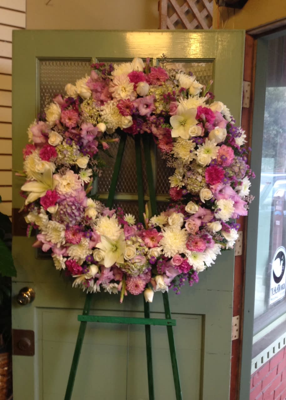 Large pastel floral wreath on a standing easel