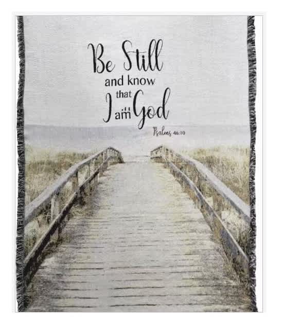 Framed wall hanging with a boardwalk scene and the words "Be Still and know that I am God"