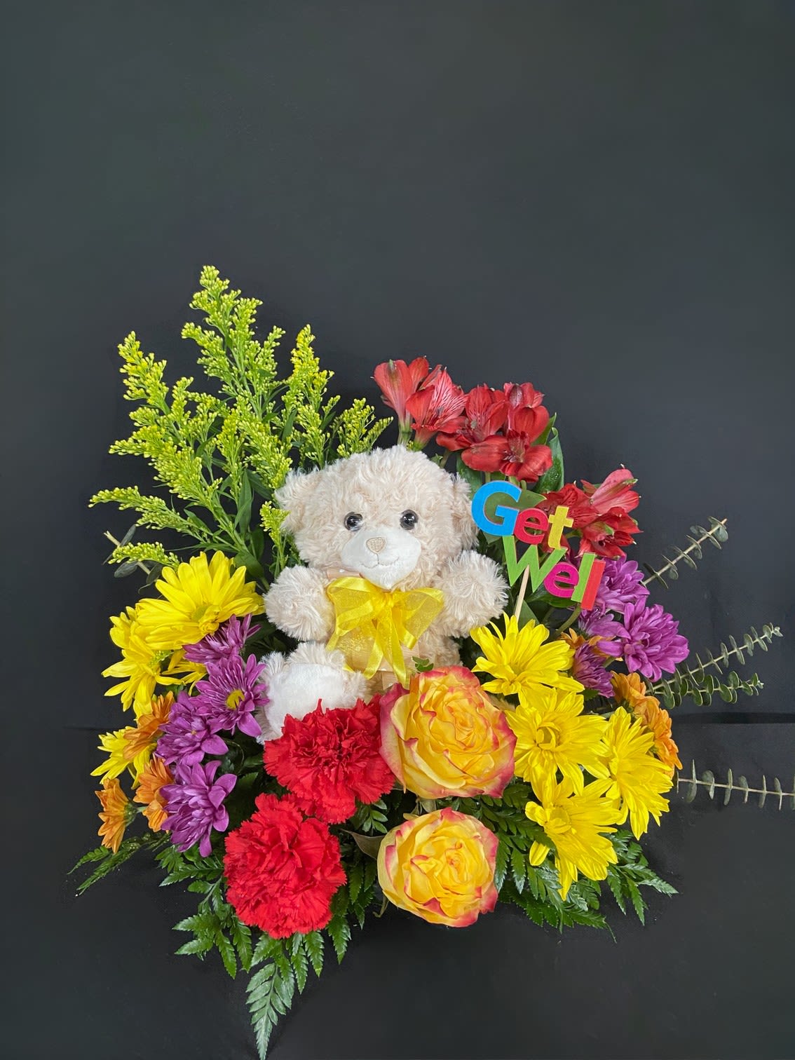 Feel Bear-ter! - What could brighten someone's day better than a snuggly bear surrounded by colorful flowers! Send well wishes to someone special with this one-of-a-kind arrangement filled with roses, carnations, and daisies.