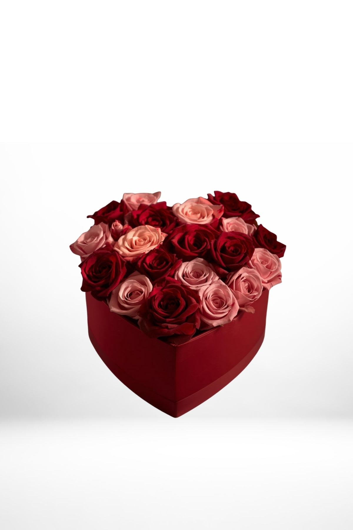 Heart-shaped box filled with red and pink roses