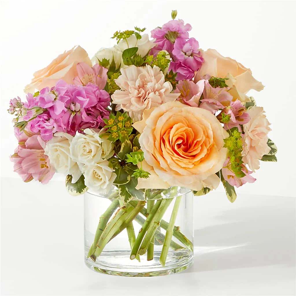 Paradise Bouquet - Relaxation and serenity can be found in the gorgeous pinks and peaches of the Paradise Bouquet.  Details The Standard Bouquet is approximately 9"H x 13"W. Designed by florists, ready to display. For long–lasting blooms, replace the water daily. We suggest trimming the stems every couple days. Pet Safety Precautions: This bouquet or plant may include flowers and foliage that are known to be toxic to pets. To keep them safe, be sure to keep this arrangement out of your pet's reach.  Bloom Details Rose Alstroemeria Carnation Stock