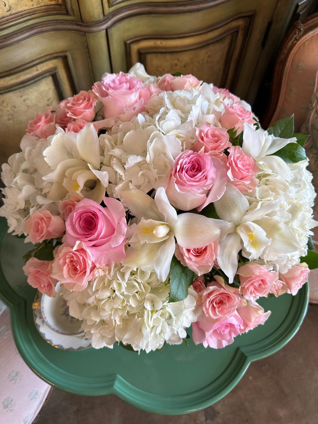 Spring Romance - Beauty in simplicity. This elegant arrangement features a white palette with soft touches of pink and fresh greenery—understated, refined, and perfect for celebrations, gratitude, or any moment that calls for a graceful gesture.  Please note: Seasonal flowers may vary based on availability, ensuring each arrangement is unique and fresh.  Freshness Guarantee: We stand behind our quality. Your flowers are guaranteed to look fresh and beautiful for 3–5 days from delivery.  To help them last:  •Top off the vase with clean water daily.  •Keep arrangements away from direct sun, heat, and drafts.  •Trim stems slightly after a couple of days if possible.