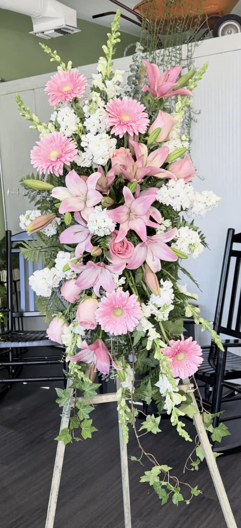 Tall pink and white floral standing arrangement on an easel