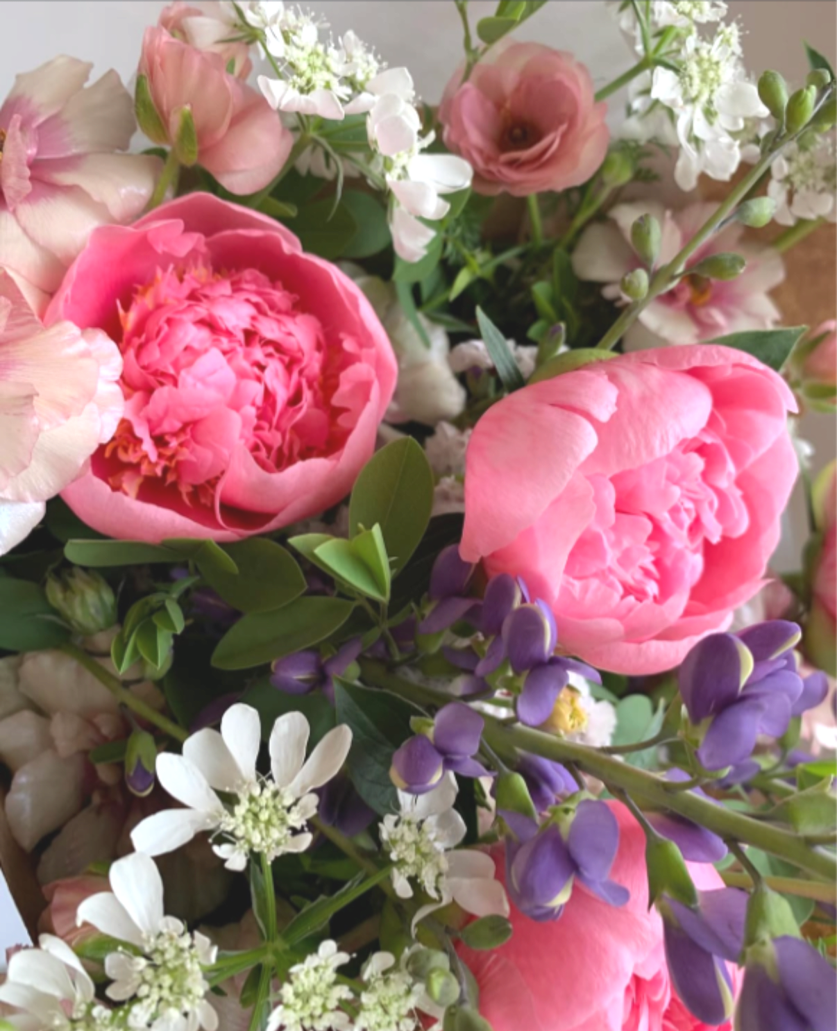 Spring Market Bouquet - Send a bit of spring goodness ready for your recipient to drop into their favorite vessel.  This seasonal wrapped mix may include blooms such as peony, tulips, ranunculus, anemone &amp; stock.   All of our flowers are seasonal, locally sourced and American grown. This allows you to receive the freshest seasonal flowers possible for a longer lasting bouquet or arrangement. Each arrangement produced is unique to the season and may contain different flowers than what are listed here. 