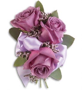 Small bouquet of lavender roses with satin ribbon and greenery