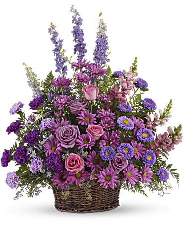 Basket arrangement of purple and pink flowers with tall spikes