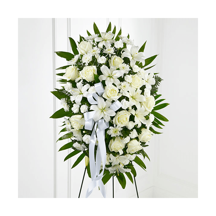 The FTD® Exquisite Tribute™ Standing Spray - The FTD® Exquisite Tribute™ Standing Spray is an elegant display of sweet serenity. White roses, Asiatic lilies, chrysanthemums and mini carnations are artfully arranged amongst emerald palm fronds and lush greens. Accented by white satin ribbon and standing on a wire easel, this standing spray is an outstanding way to honor the life of your loved one.   SKU#: S6-4447