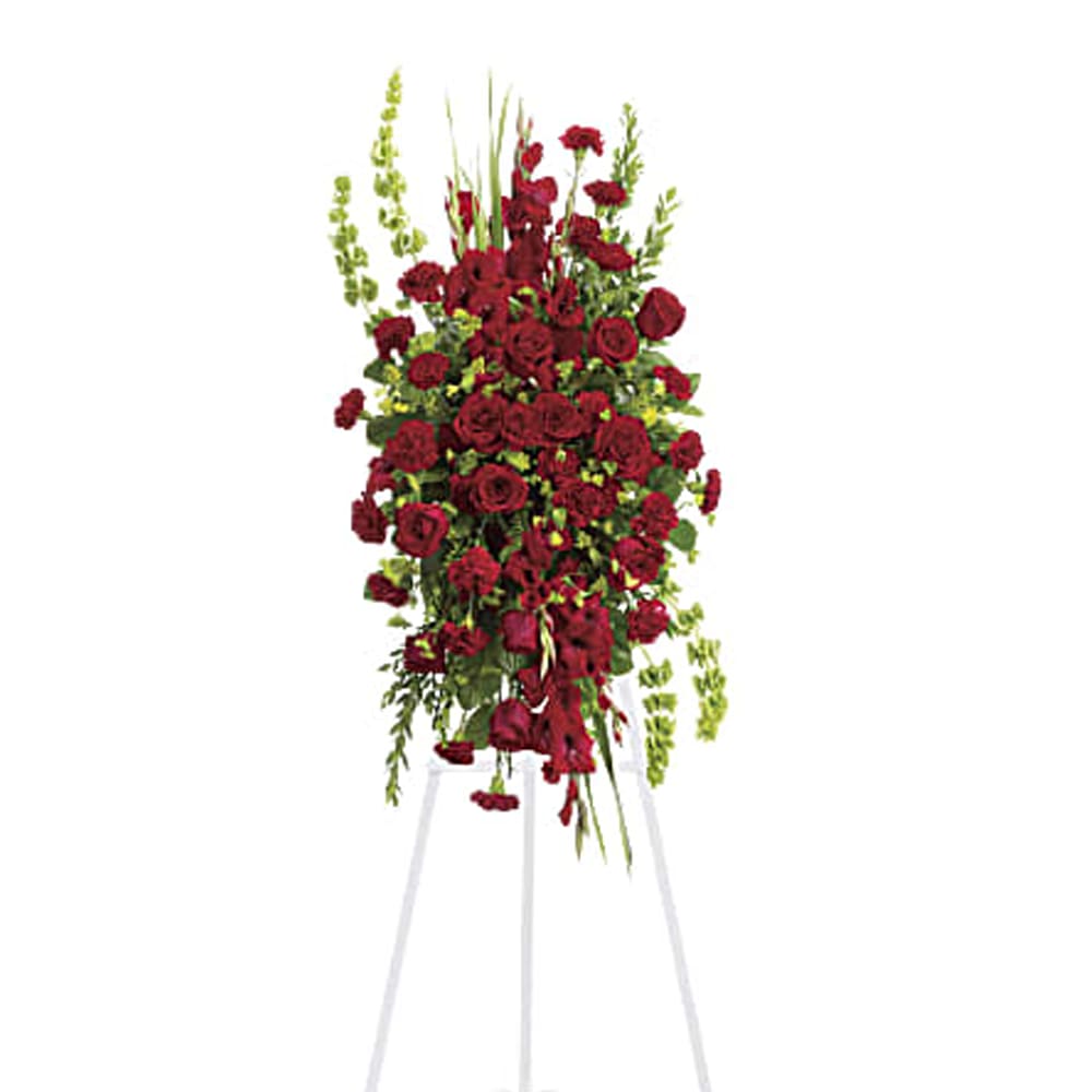 Tall red floral standing spray on a white easel