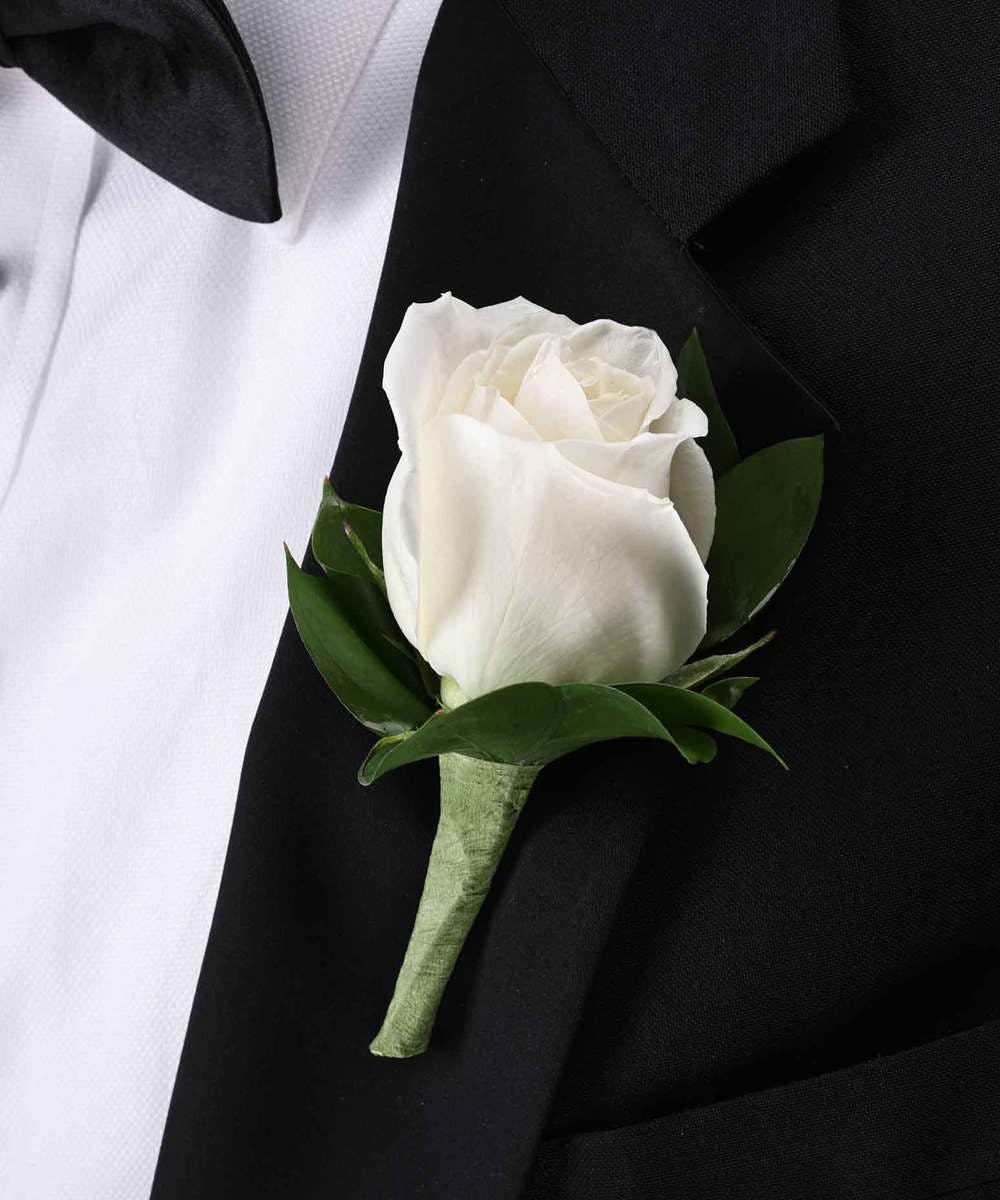 White rose boutonniere on a black suit jacket
