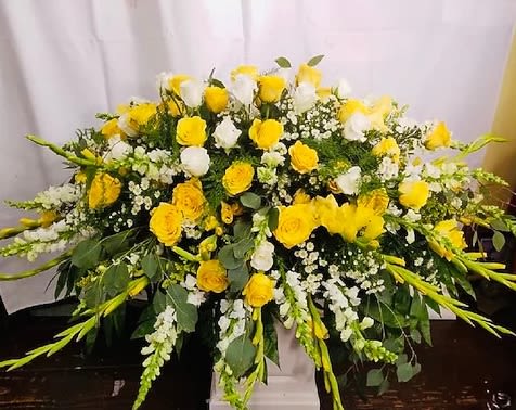 Rays of Hope Casket Spray - Remember the life of your loved one with this beautiful yellow and white casket spray, rays of sunshine in loving tribute.