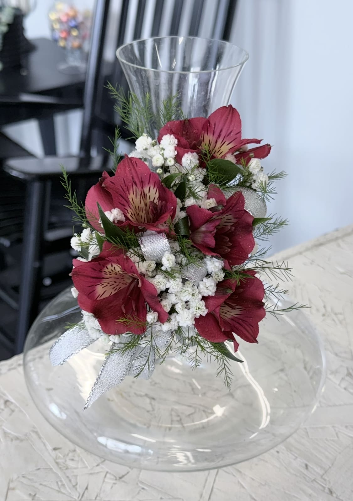 Pink alstroemeria arrangement in a clear glass vase with white filler flowers