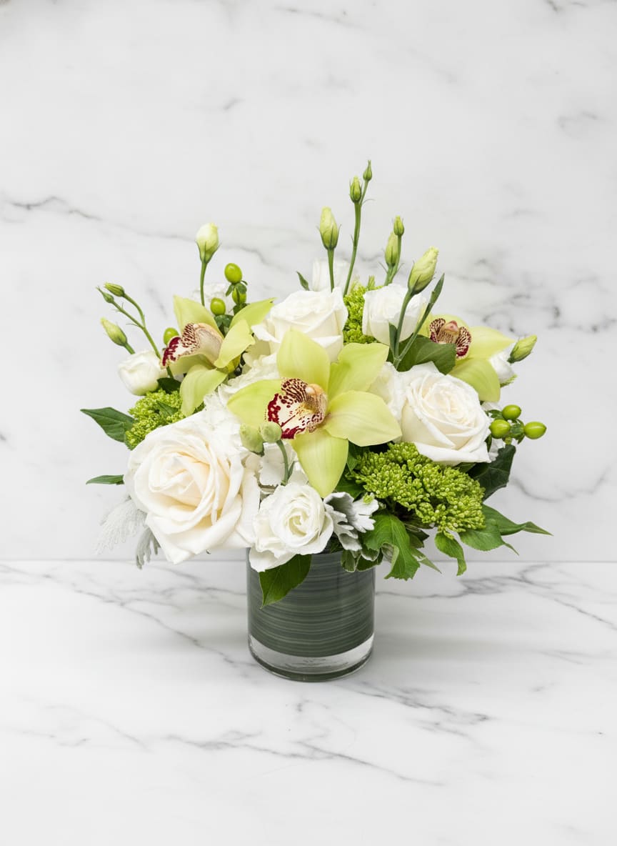 Green Goddess - Fresh, elegant, and effortlessly sophisticated, Green Goddess features lush green cymbidium orchids, premium white roses, delicate lisianthus, hypericum berries, and seasonal accents artfully arranged in a modern glass vase. The soft ivory and vibrant green palette creates a timeless look that is equally suited for birthdays, thank-you gifts, sympathy sentiments, corporate gifting, and everyday occasions. Handcrafted by the designers at Polk Street Florist and available for local delivery throughout San Francisco.