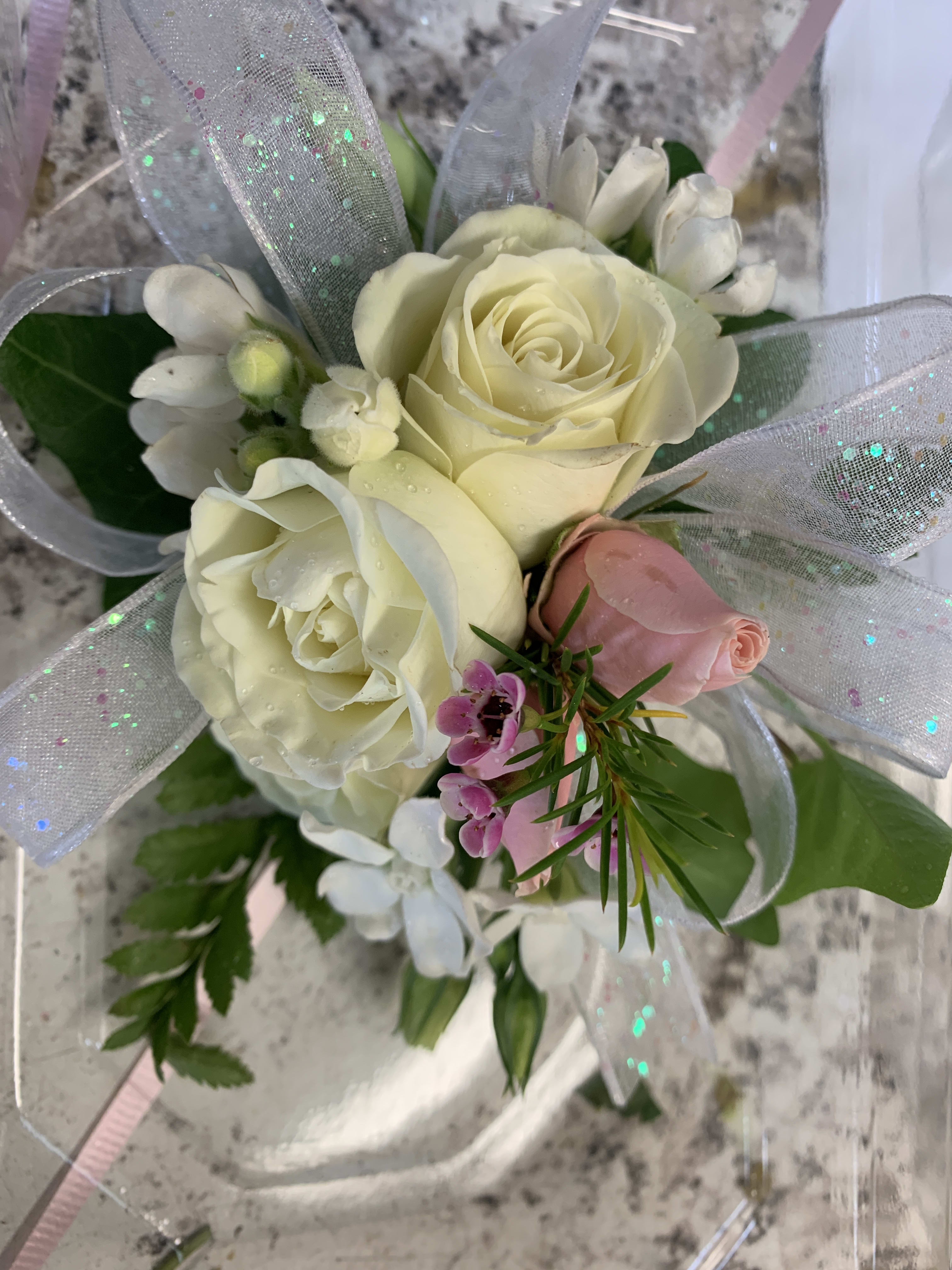Small bouquet of white and pink roses with silver ribbon