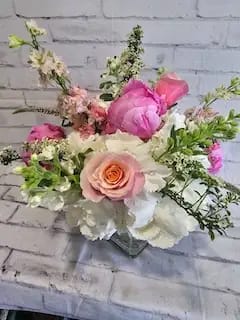 Pink and white mixed flower bouquet in a glass vase