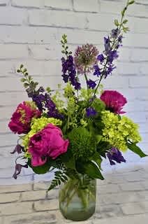 Pink and purple mixed bouquet in a glass vase