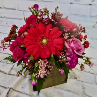 Red gerbera bouquet with pink roses in a square box