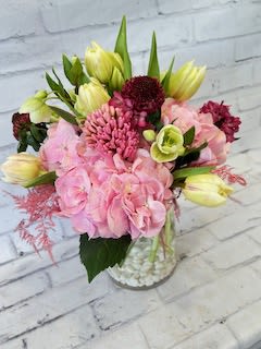 Pink and yellow mixed bouquet in a clear glass vase