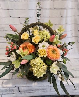 Mixed bouquet with orange and yellow blooms and pink tulips