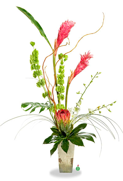 Tall tropical arrangement with pink blooms in a square vase