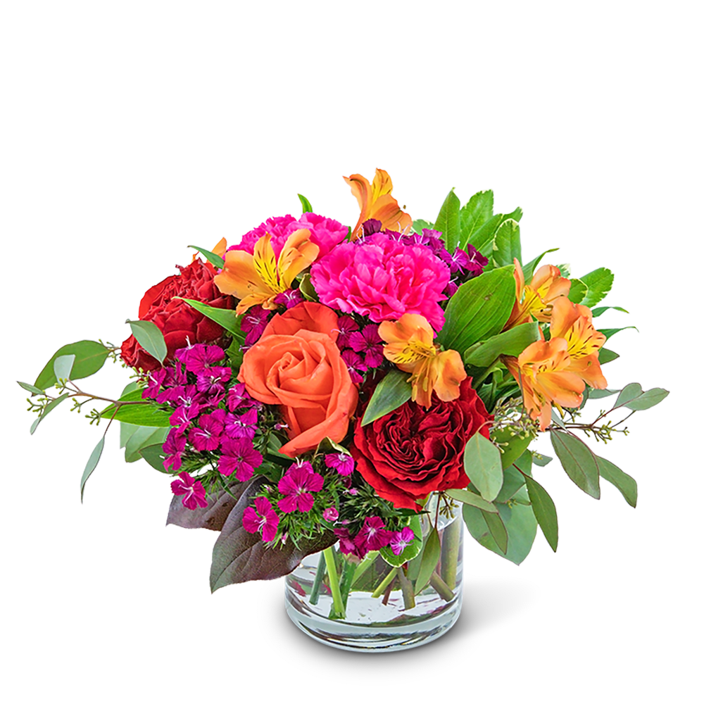 Bouquet of red and orange roses with pink flowers in a clear glass vase