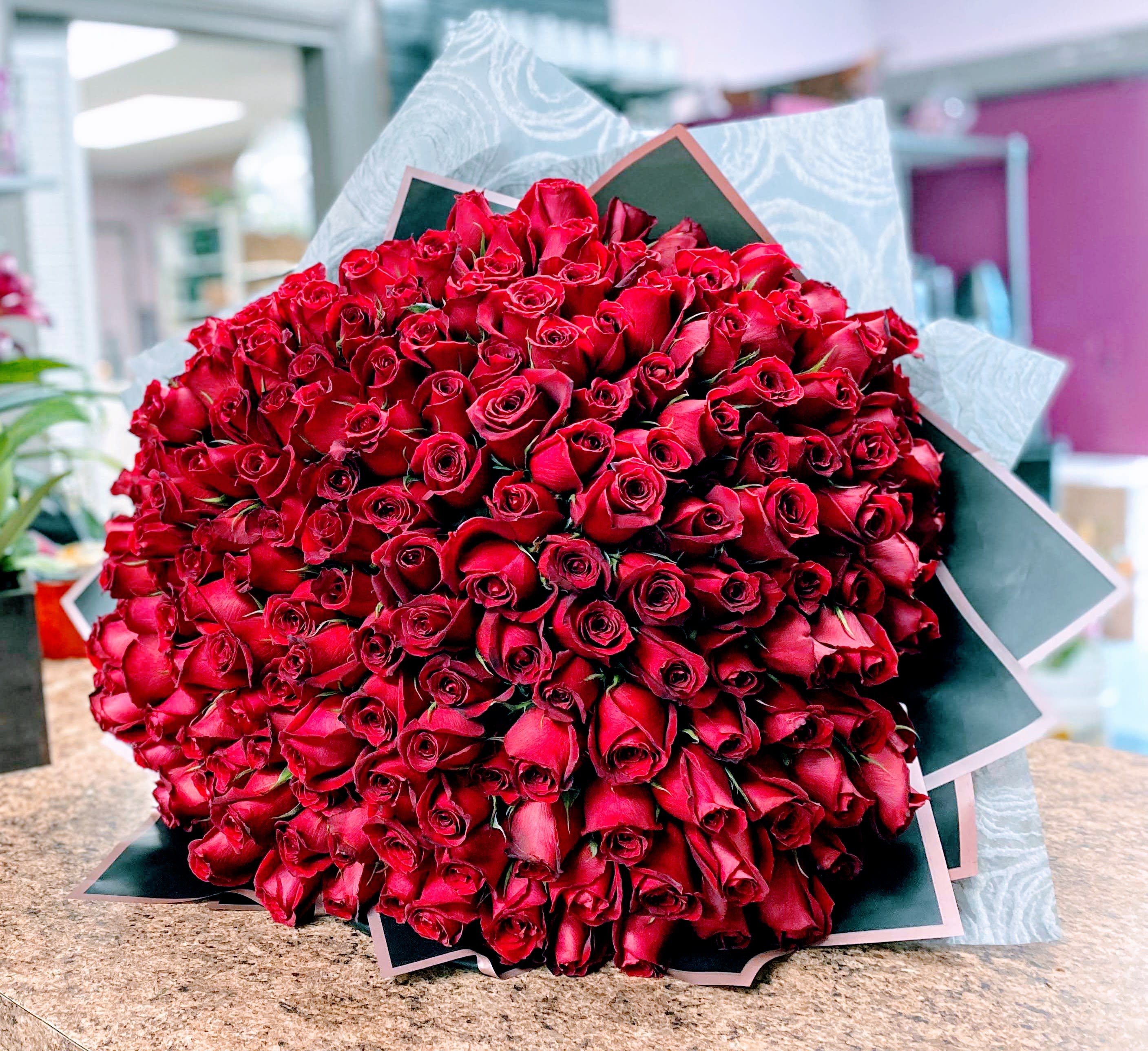 Large bouquet of red roses wrapped in paper