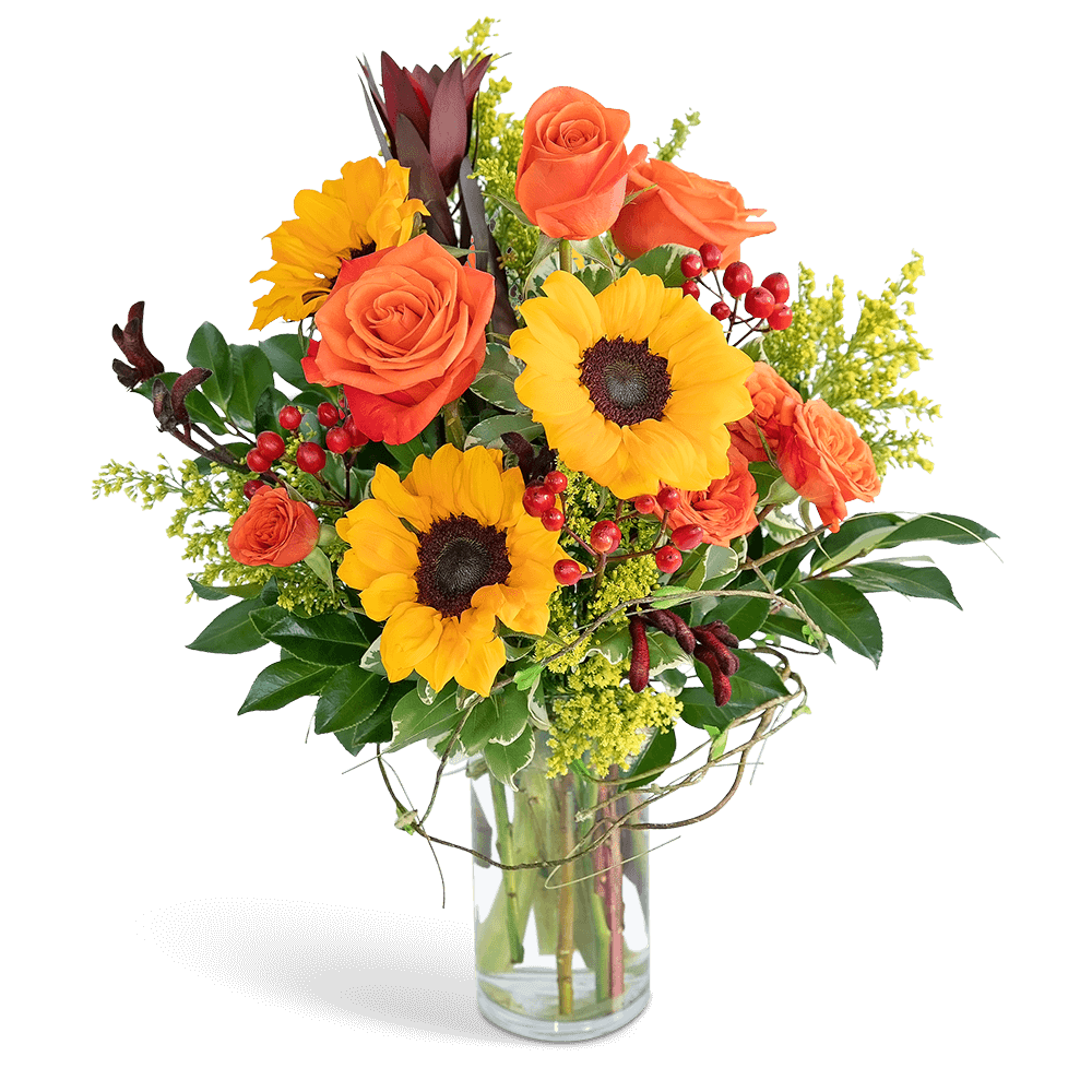 Bouquet of orange roses and yellow sunflowers in a clear glass vase