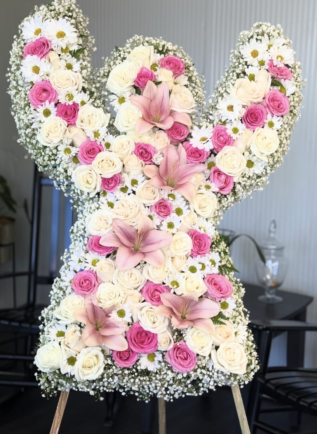 Large floral arrangement shaped like the number 50 with pink and white roses and lilies
