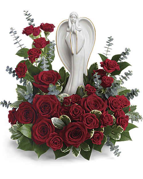 Forever Our Angel - Elegant and emotional, this touching arrangement of rich red roses with delicate greens surrounds a peaceful porcelain angel sculpture keepsake. 