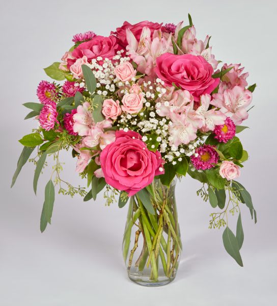 Pink roses and alstroemeria in a clear glass vase