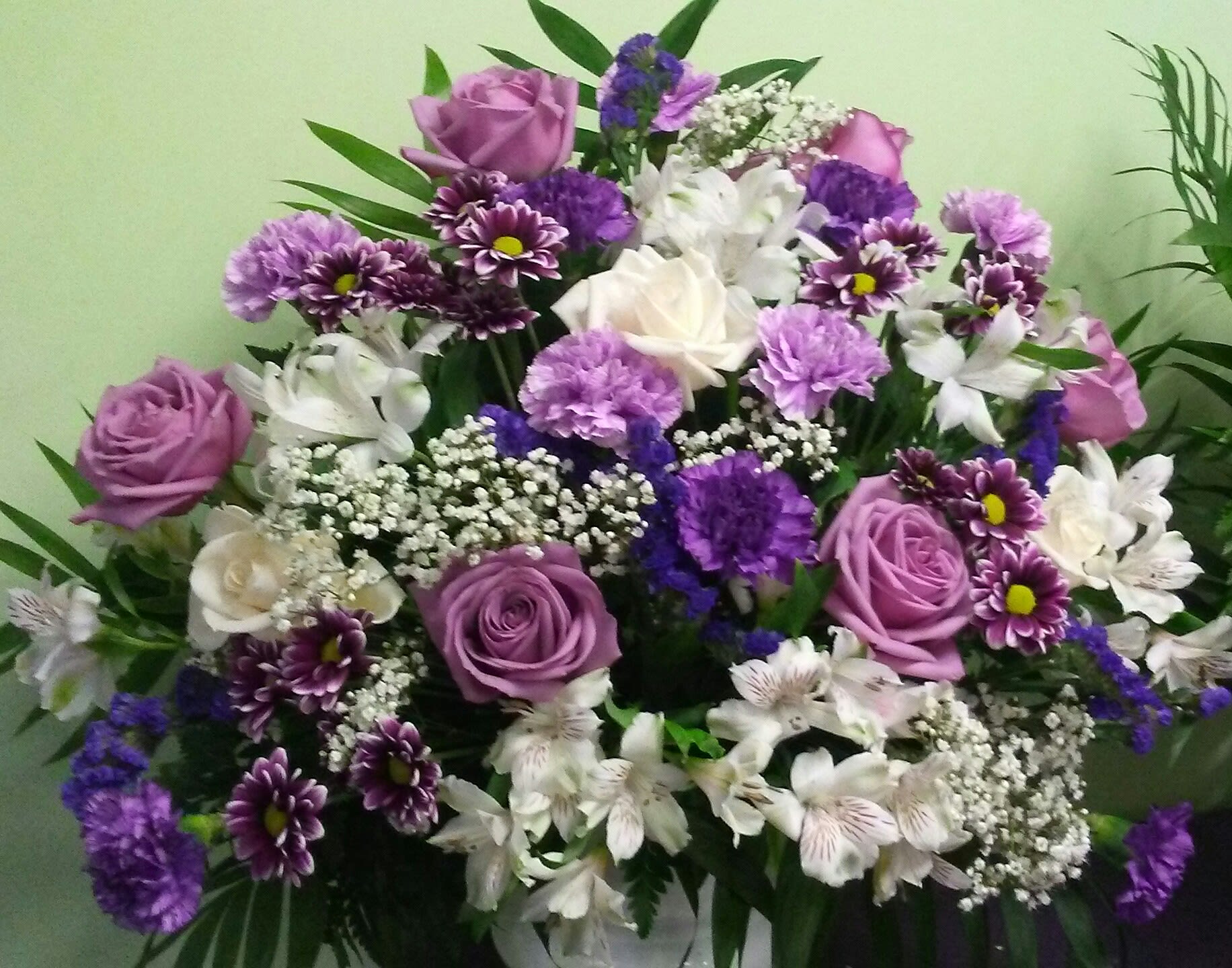 Bouquet of purple and white roses with mixed purple flowers