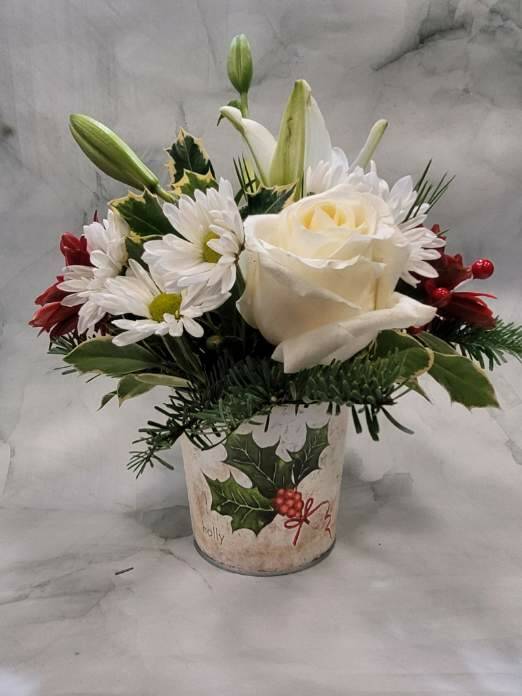 Bucket of Joy - This arrangement is arranged in a metal holly bucket planter that is perfect for sending some joy. This arrangement is full of Christmas joy. The arrangement includes Daisy Poms, Roses, and Christmas greens. 