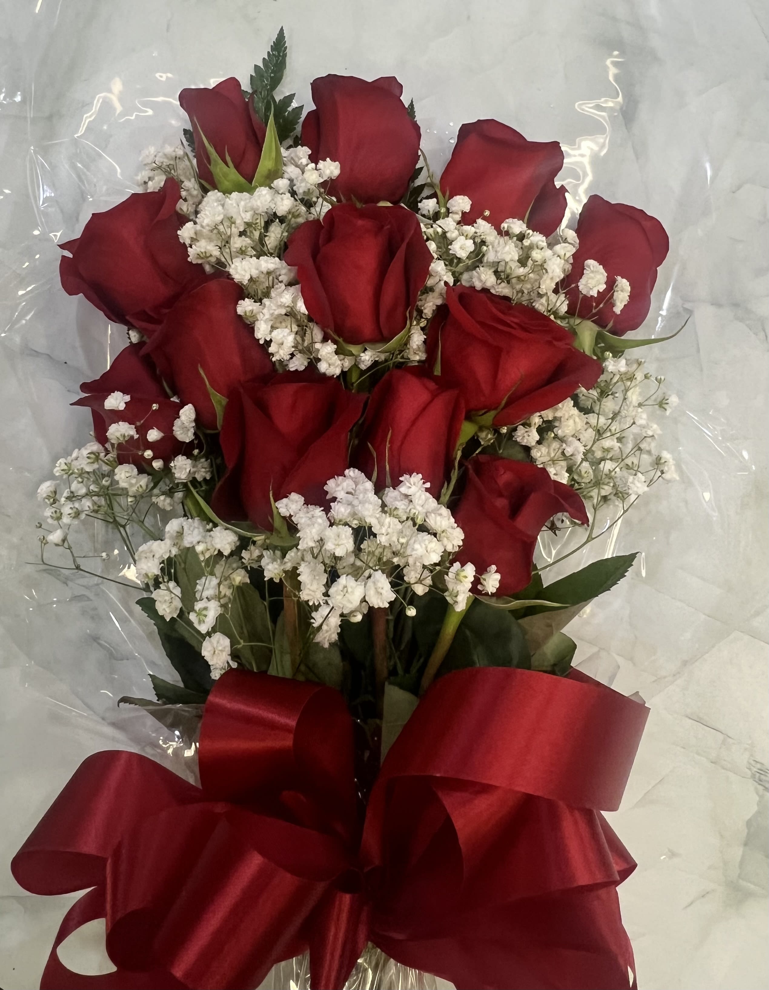Bouquet of red roses with white baby's breath and a red ribbon