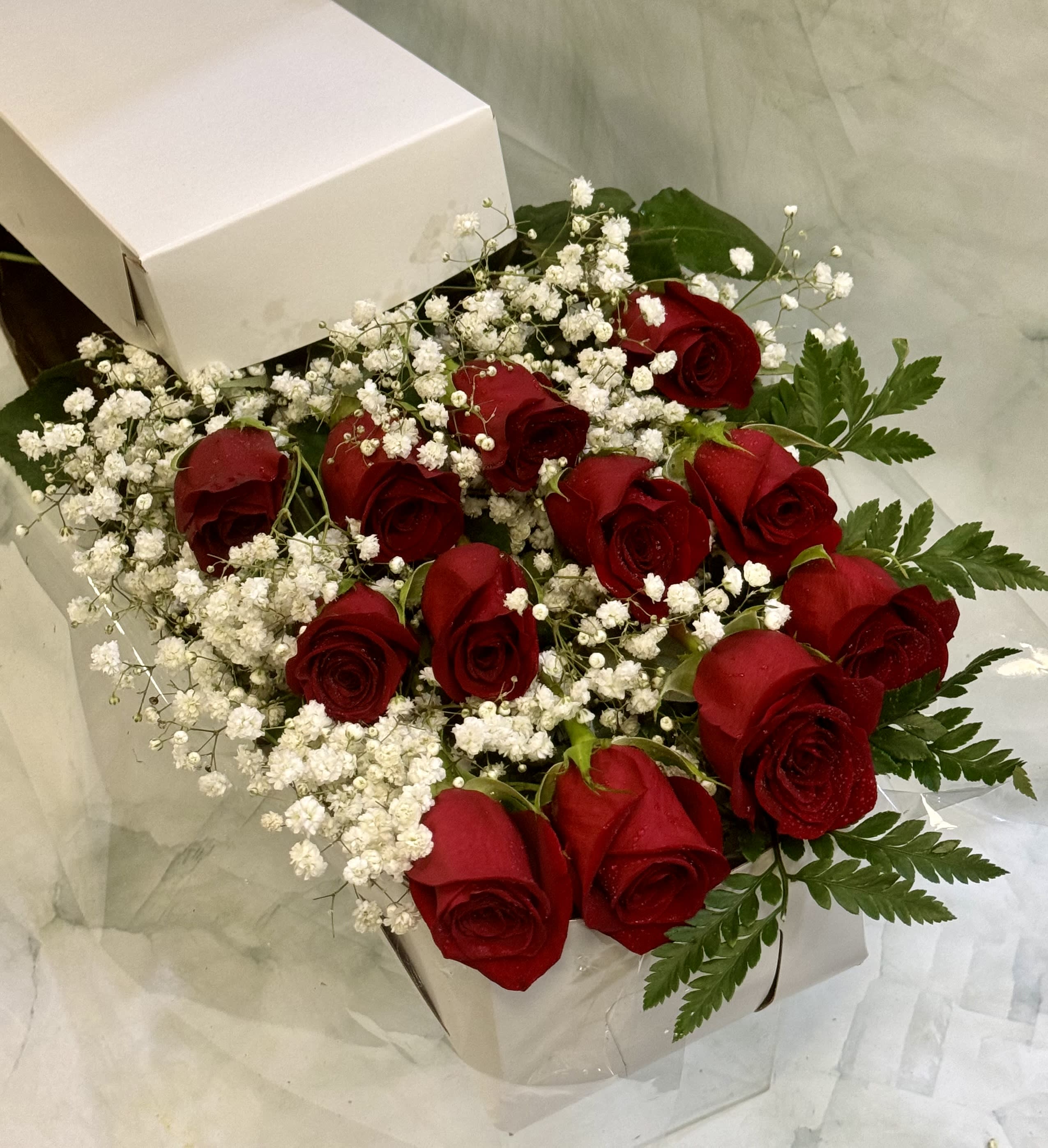 Box of red roses with white baby's breath