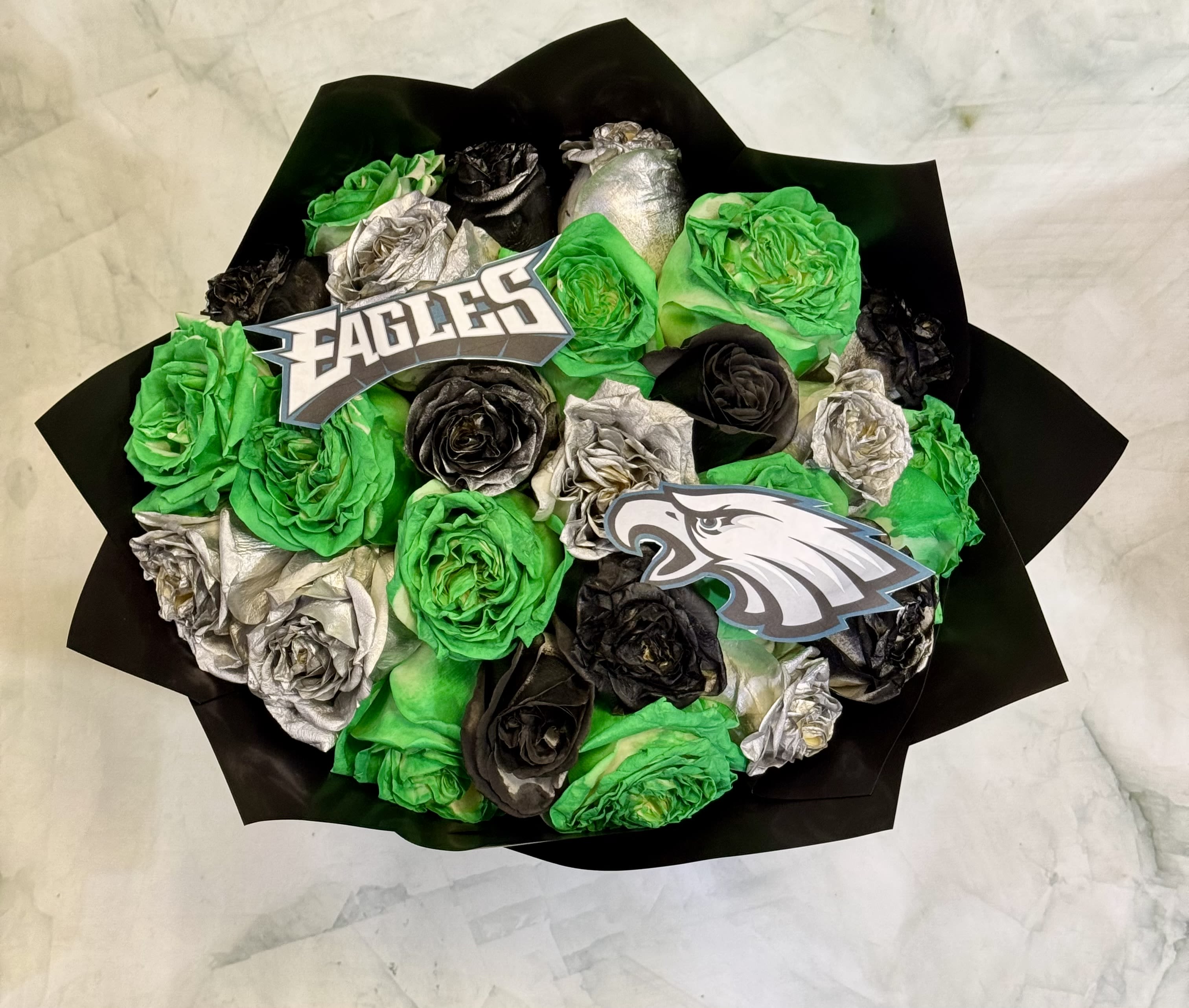 Bouquet of green, black, and silver roses with sports team picks