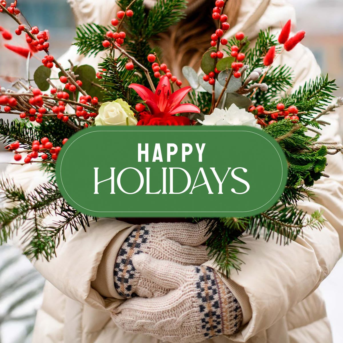 Holiday bouquet with red berries, pine, and red and white flowers