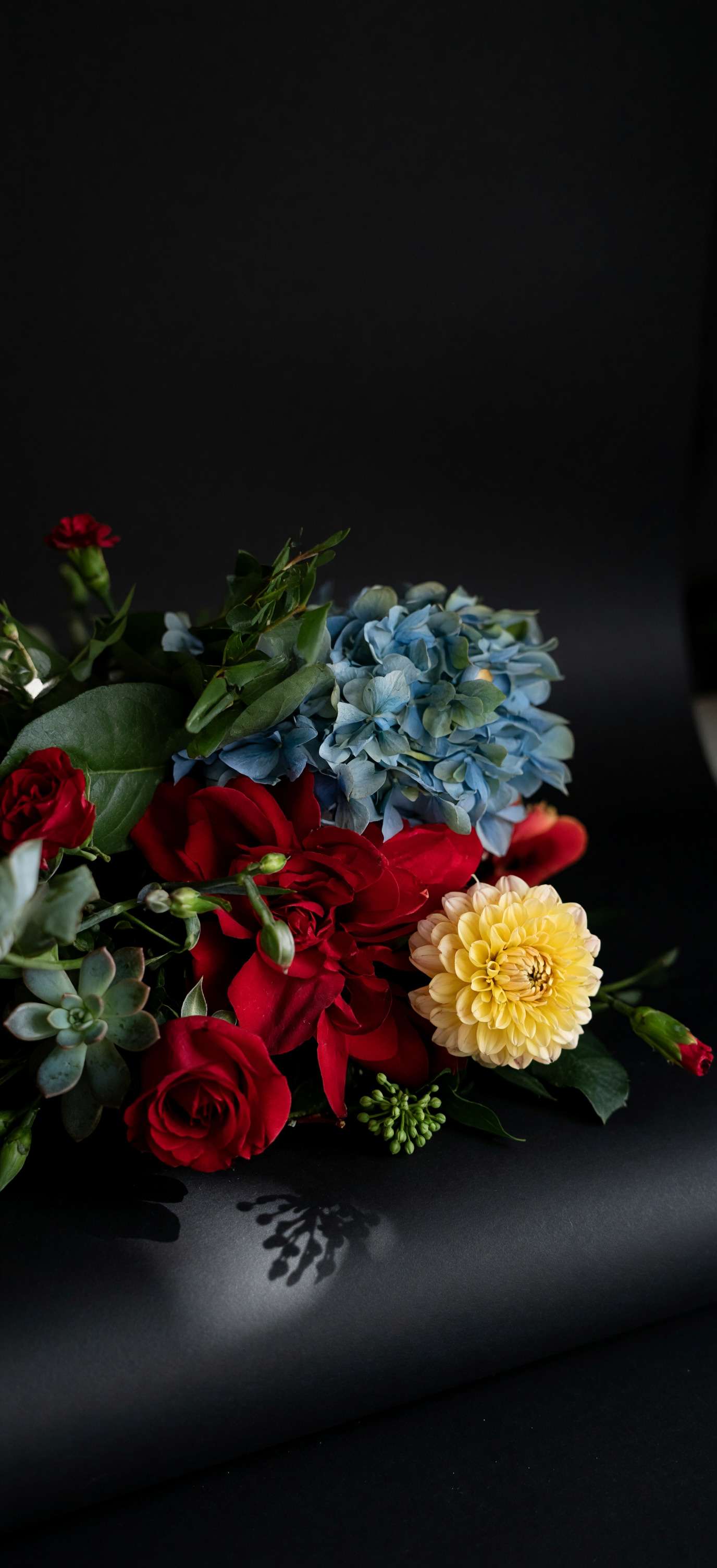 Gift card with a floral arrangement of red roses, blue hydrangea, and a yellow dahlia