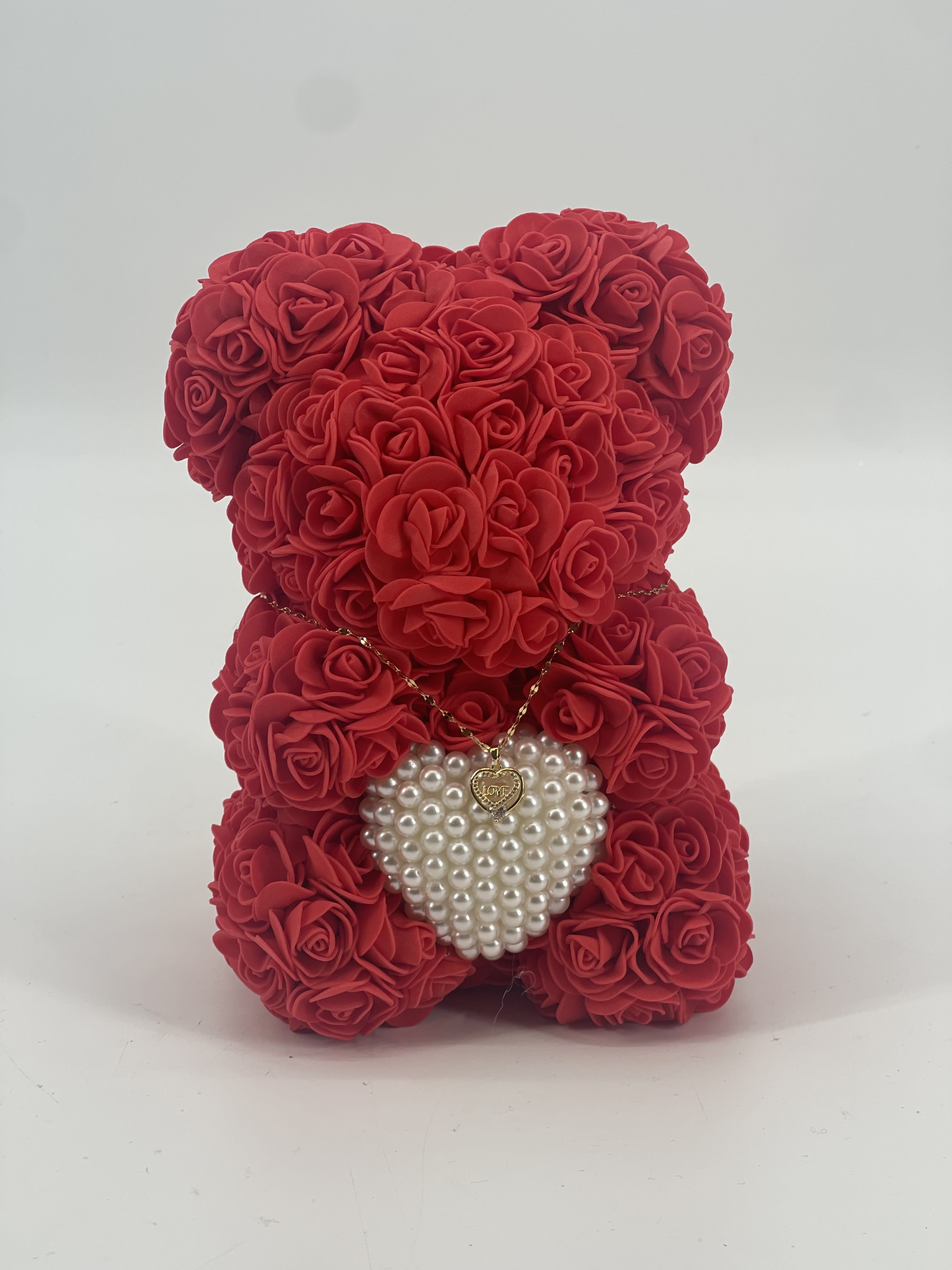 Red rose teddy bear with a pearl heart pendant