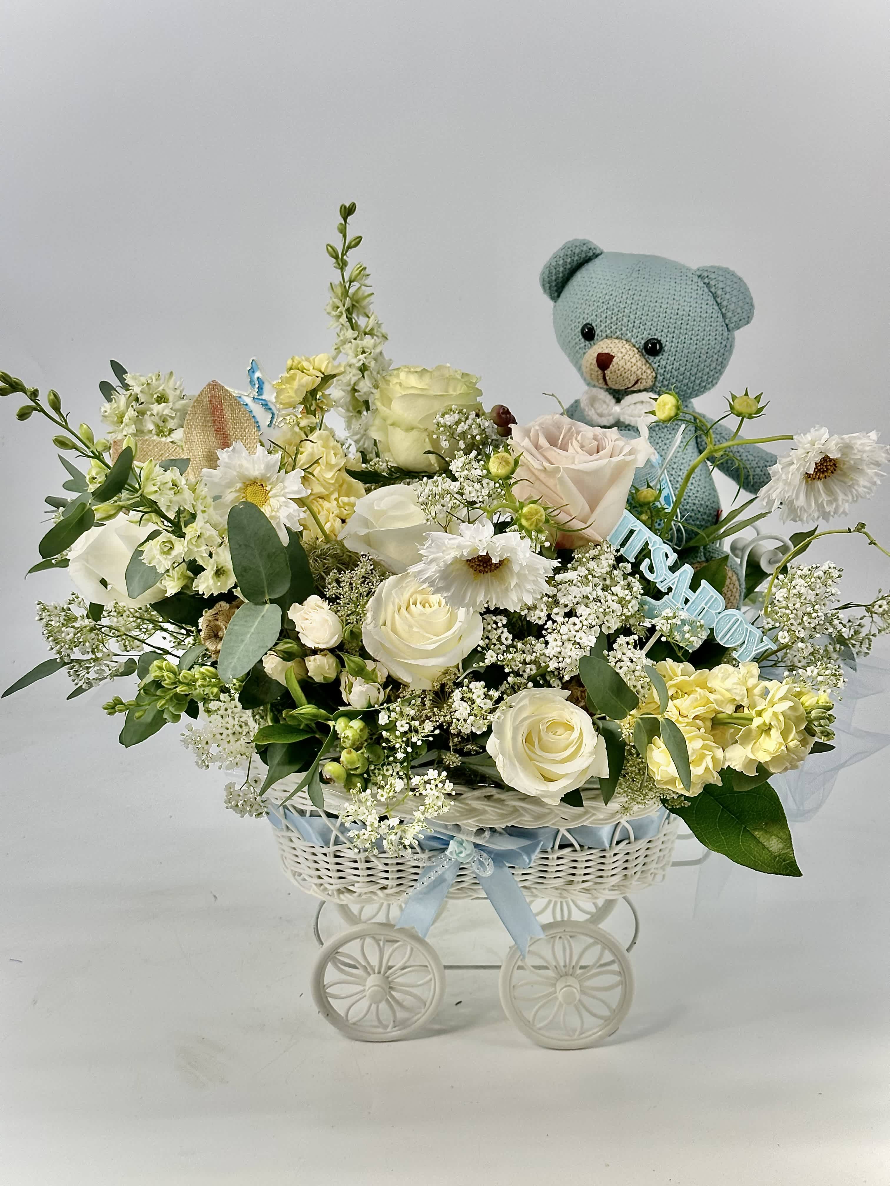  Welcome , Little Baby Boy - An elegant baby -boy arrangement of soft ivory and cream blooms accented with greenery ,thoughtfully finishes with a powder -keepsake teddy.Refined ,tender ,and timeless -designed to celebration a beautiful new beginning.Let's celebrate !