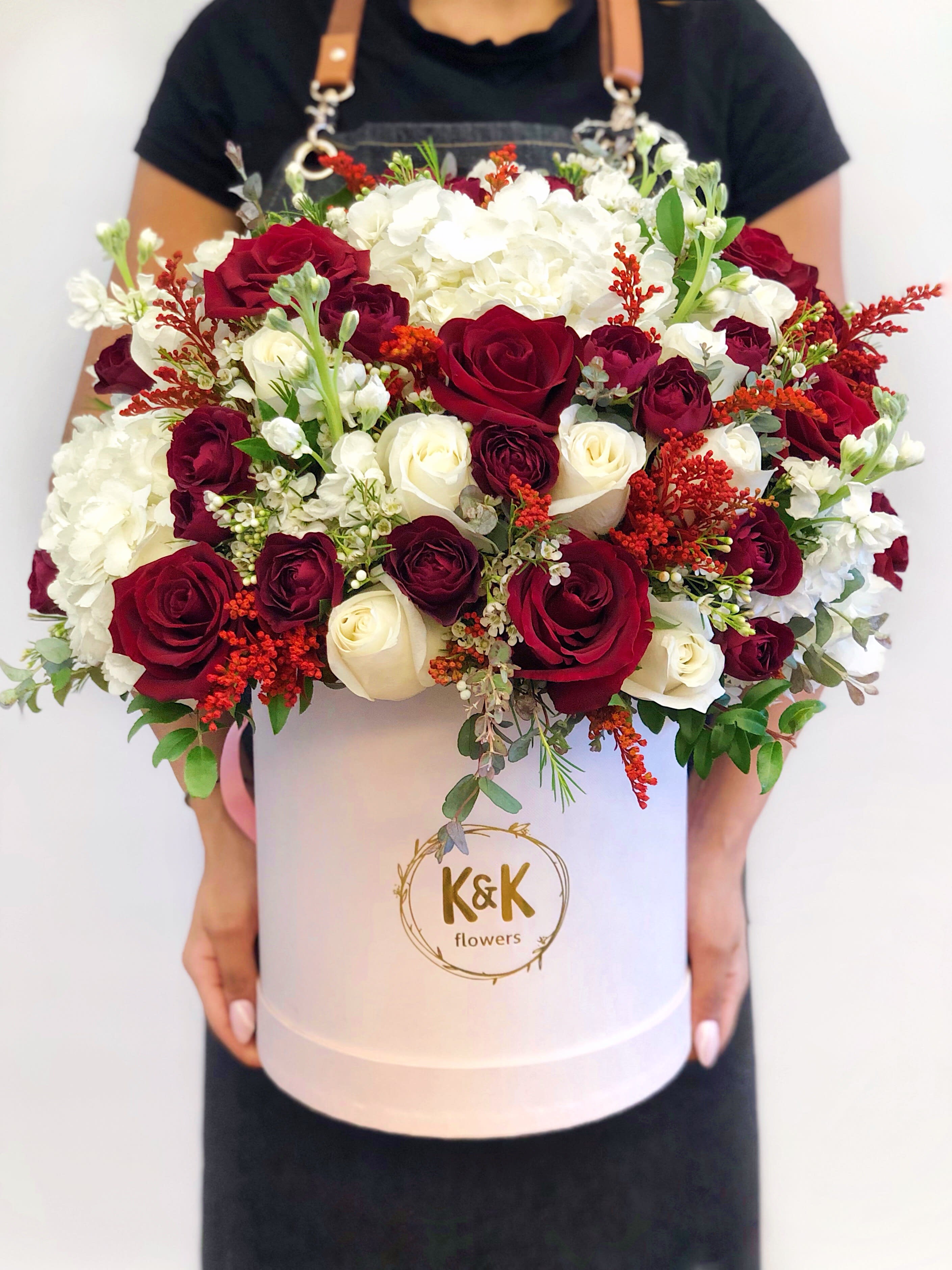 Large bouquet of red and white roses in a white hat box