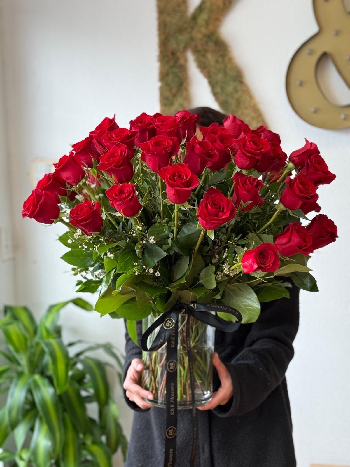 Large bouquet of red roses in a clear glass vase