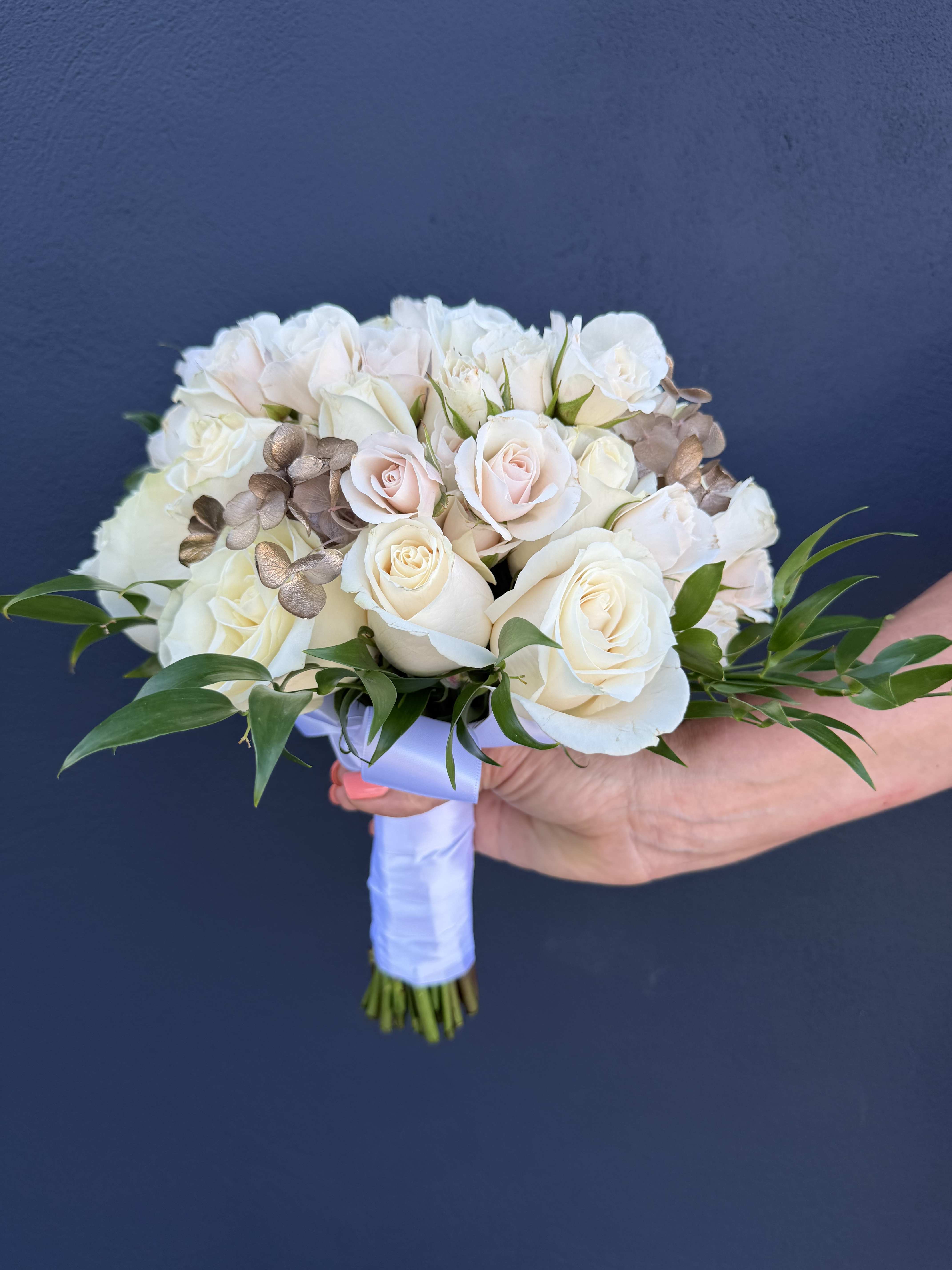 White and blush rose bridal bouquet with greenery and ribbon wrap